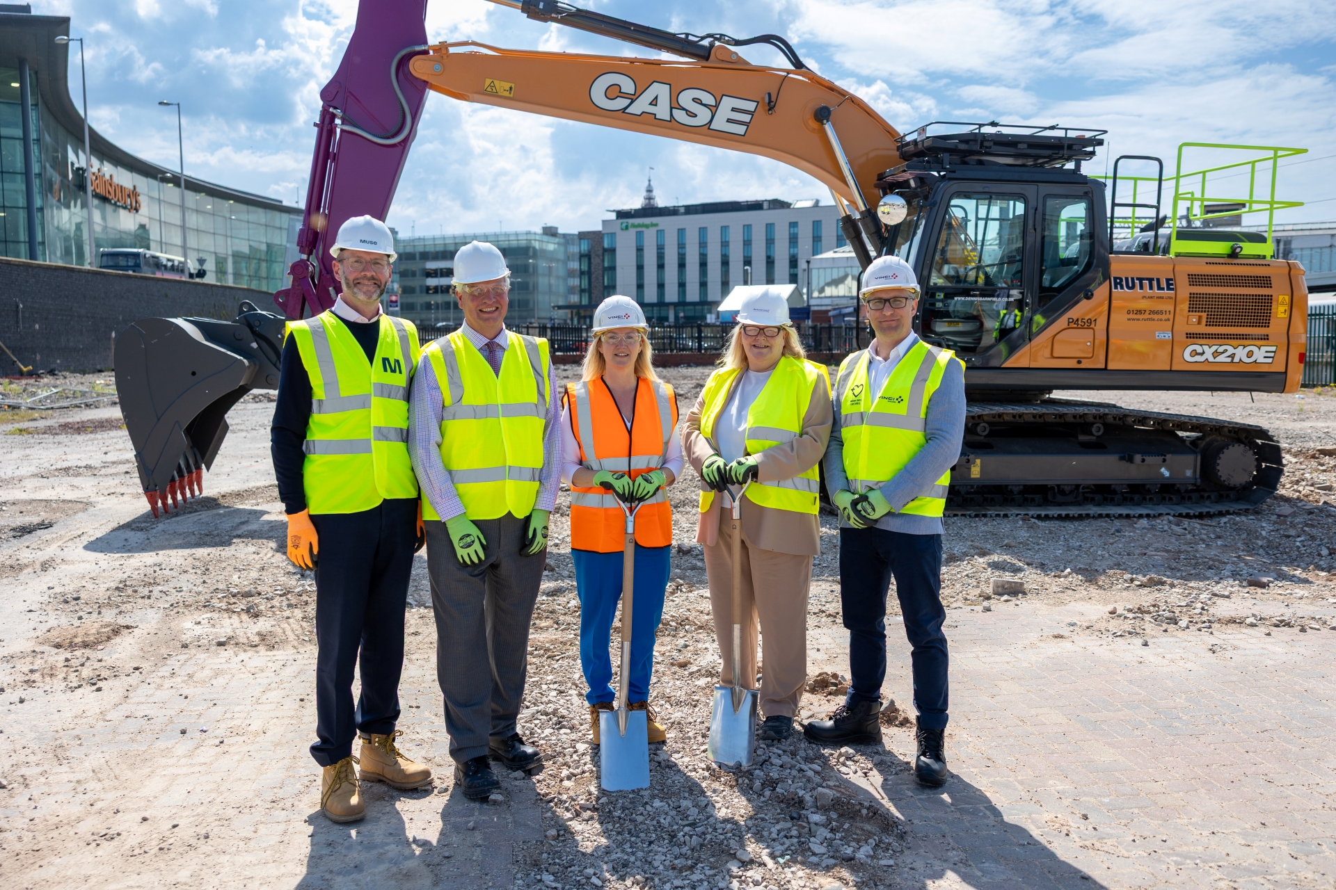 A group of people standing on a building site