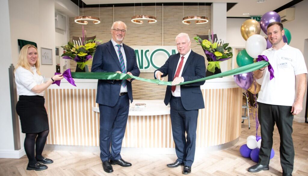 A group of people holding a ribbon