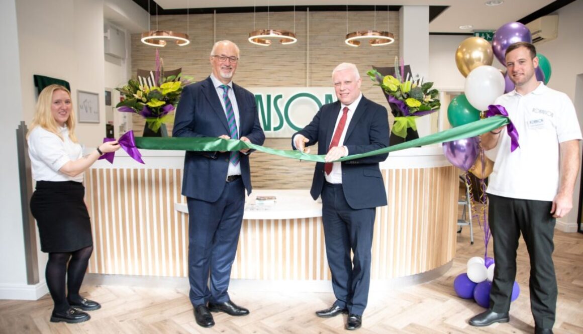 A group of people holding a ribbon